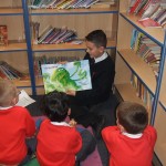 A Y7 student reading to a Y1 class