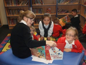 A Y7 student reading to a Y1 class
