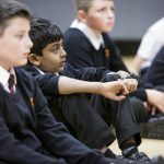 Students sitting on the floor during a lesson