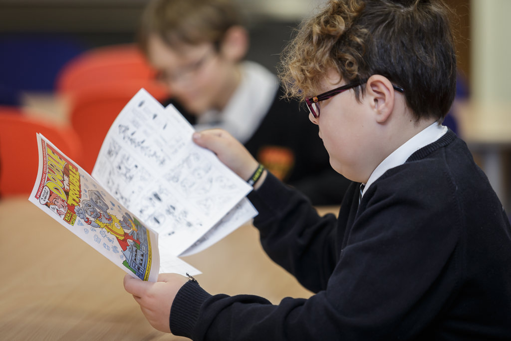 Student reads their finished comic book