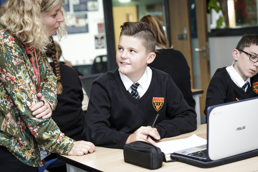 Student working with their teacher