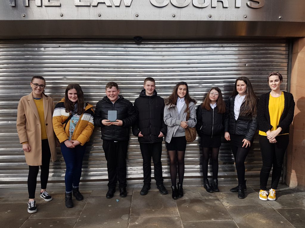 Students outside Newcastle Law Courts with their winning trophy