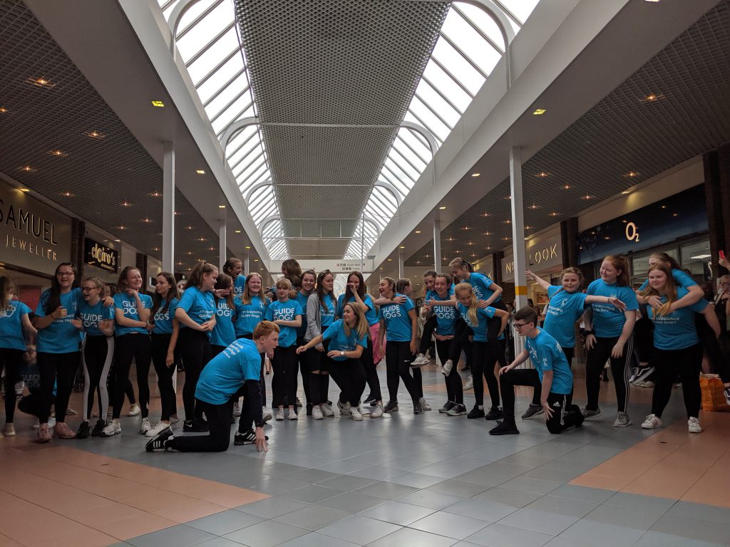 Students performing a dance routine inside a local shopping centre