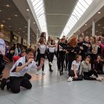 Students performing a dance routine inside a local shopping centre