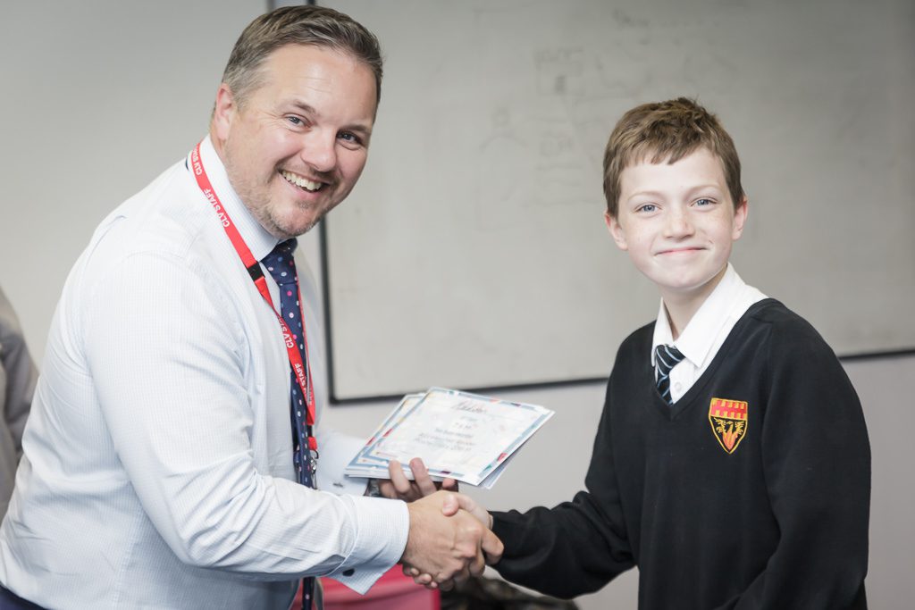 Mr Clark and a year 7 student receiving a certificate