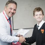 Mr Clark and a year 7 student receiving a certificate