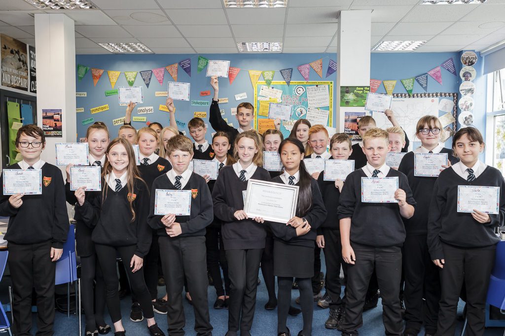 Year 7 class in a group holding their certificates