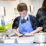 Student rolling their pasta dough