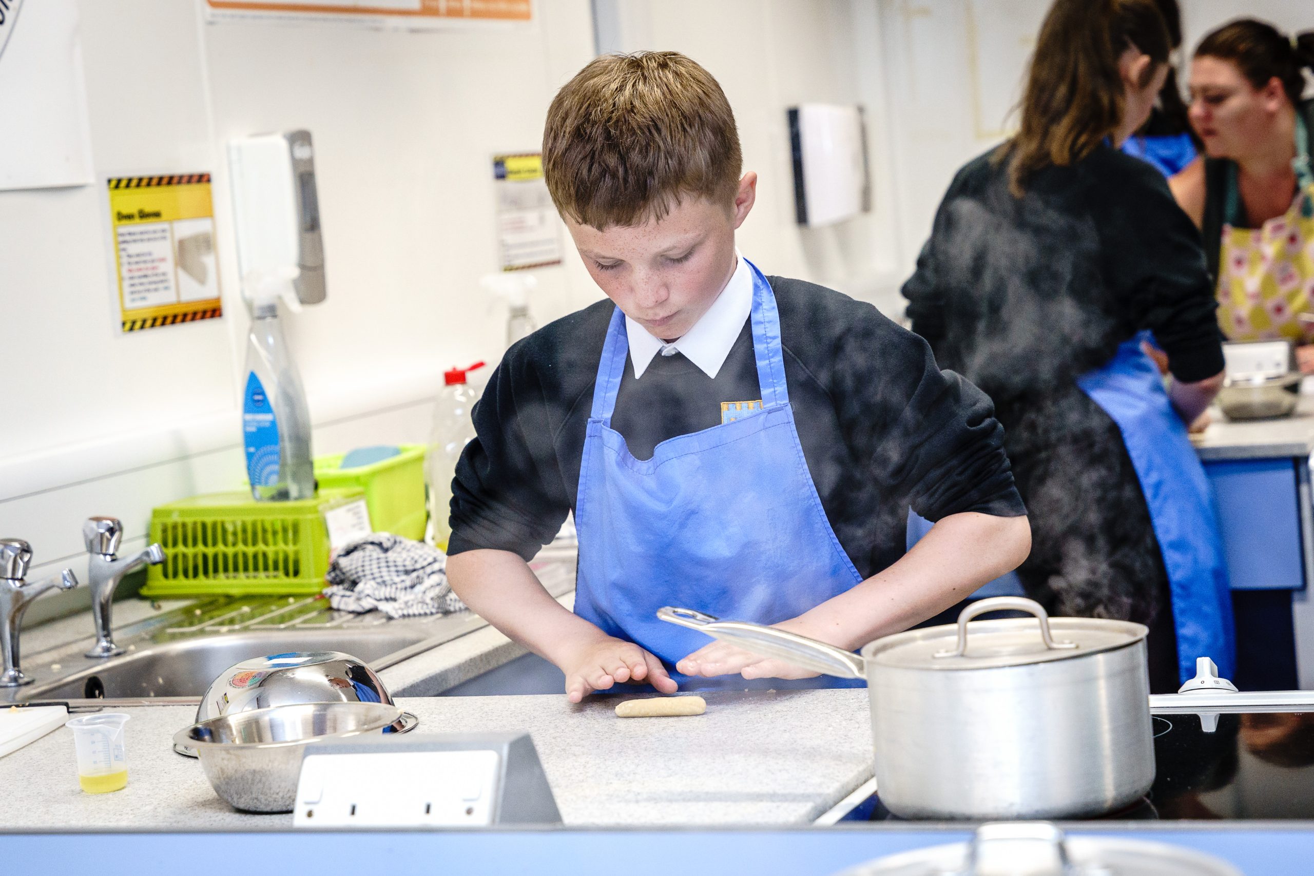 Student rolling their pasta dough