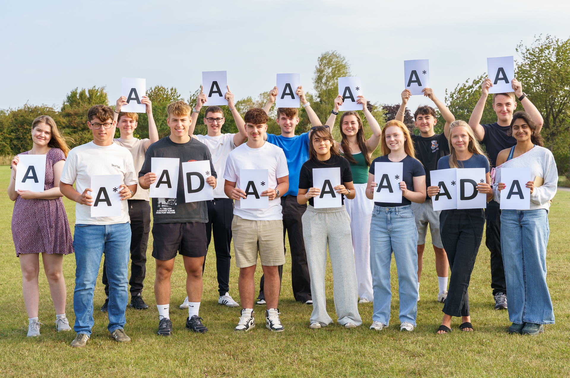 Students holding A* signs